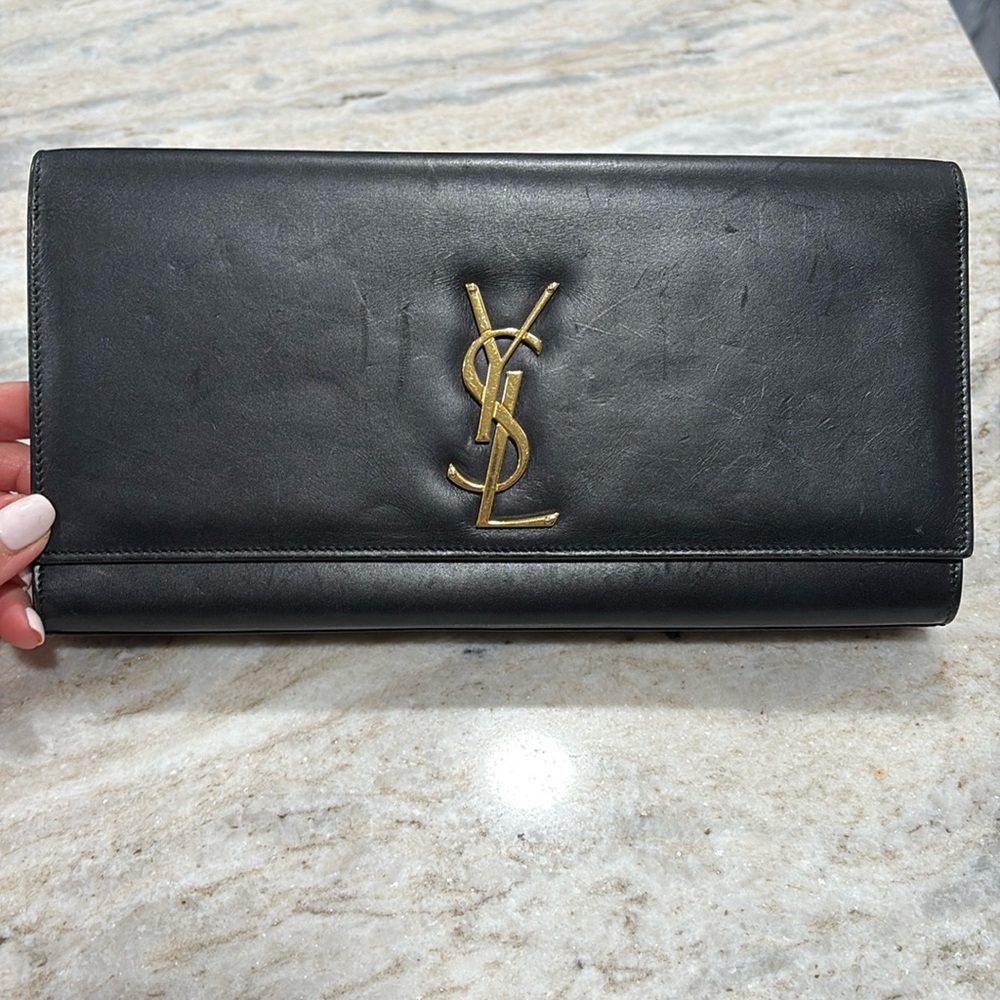 Authentic black YSL clutch with wear on the leather